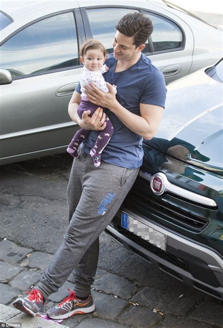 Adam Garcia cooes over baby girl Arya before Singin' In The Rain