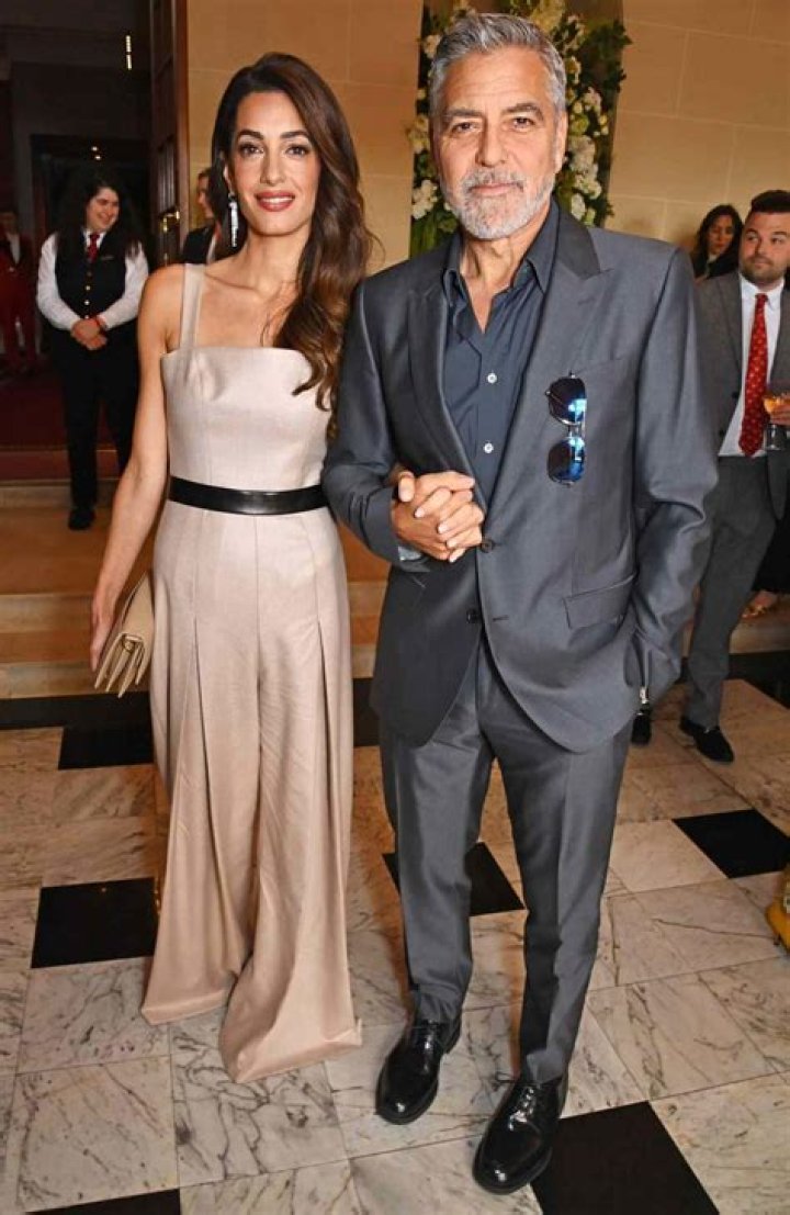 and Amal Clooney Hold Hands for Night Out at The Prince's Trust