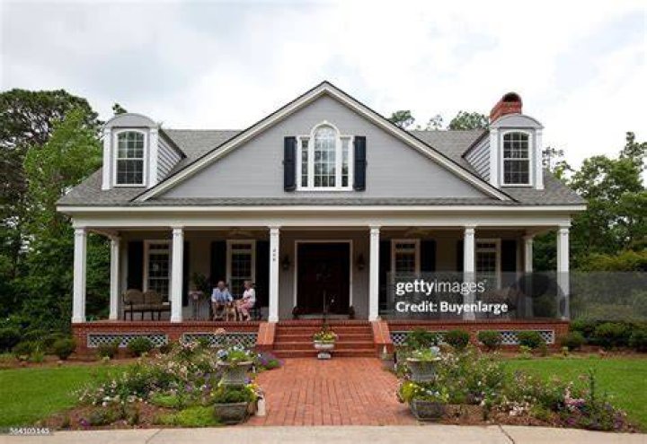 Billy Carson Bond and his wife Evelyn sitting on the porch with their