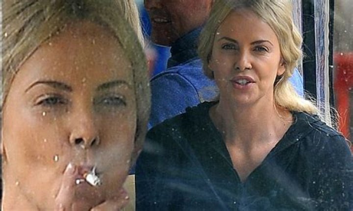 Charlize Theron puffs a cigarette on the set of The Huntsman in the UK