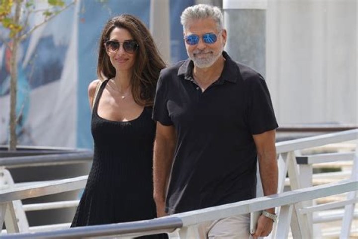 Clooney and Amal Clooney Hold Hands as They Leave Venice After