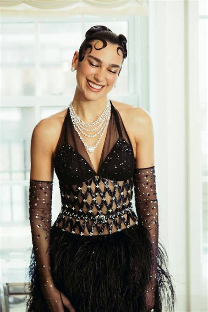 Dua Lipa looks stunning in a sheer white dress as she attends the