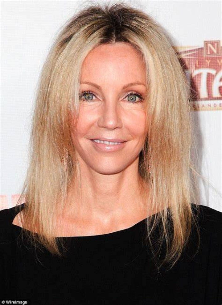 Heather Locklear, 52, clutches onto the elixir of youth (in the form of