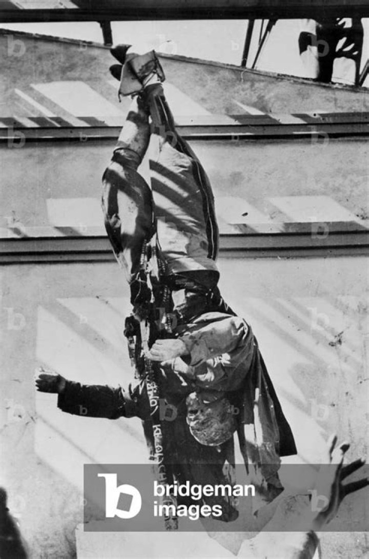 Image of The corpse of Benito Mussolini (center), surrounded by the