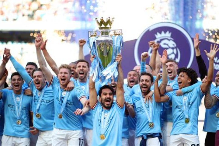 Manchester City's Vincent Kompany celebrates with his children after