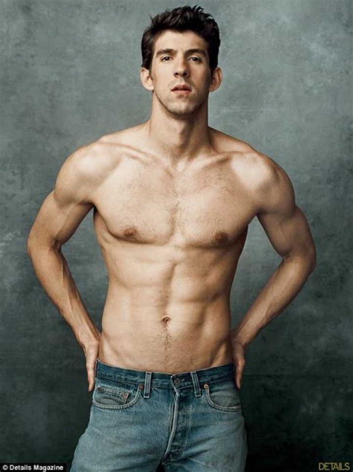 Michael Phelps strips down to show off his swimmer's body as he gets