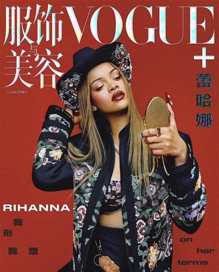 Rihanna covers her large dark roots with a bold red and white beanie