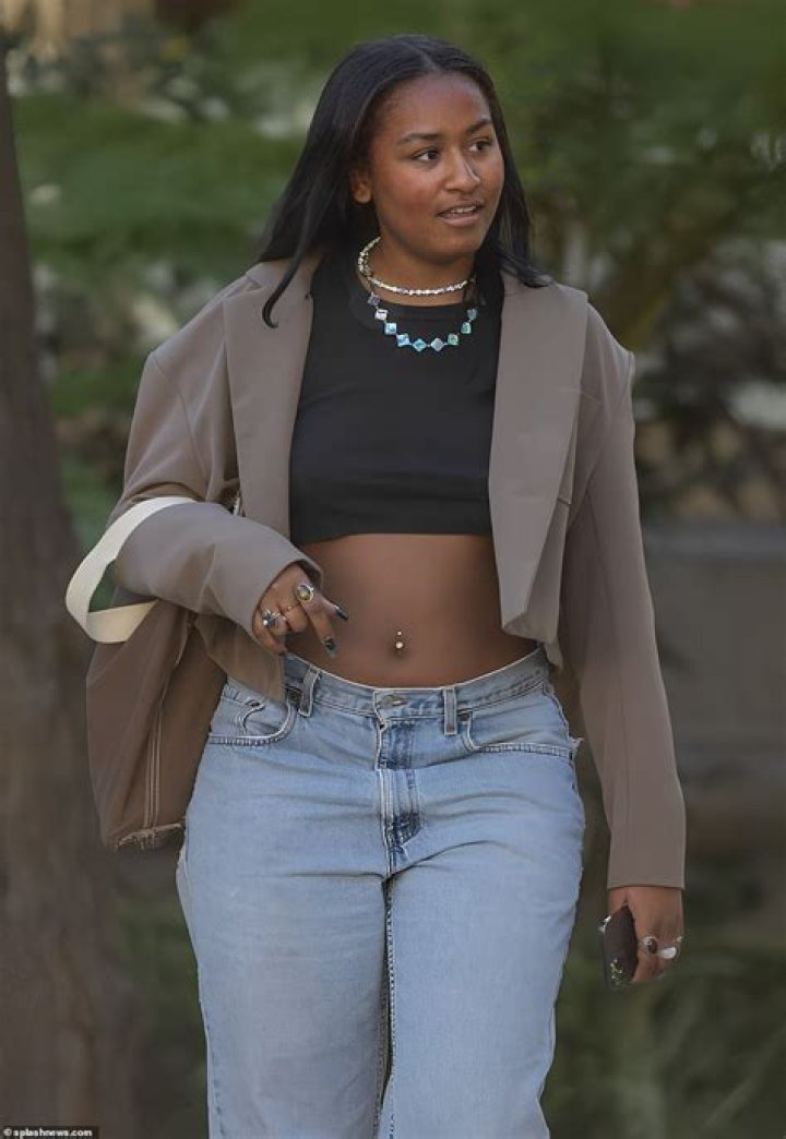 Sasha Obama flaunts her toned midriff and belly ring in tiny crop top